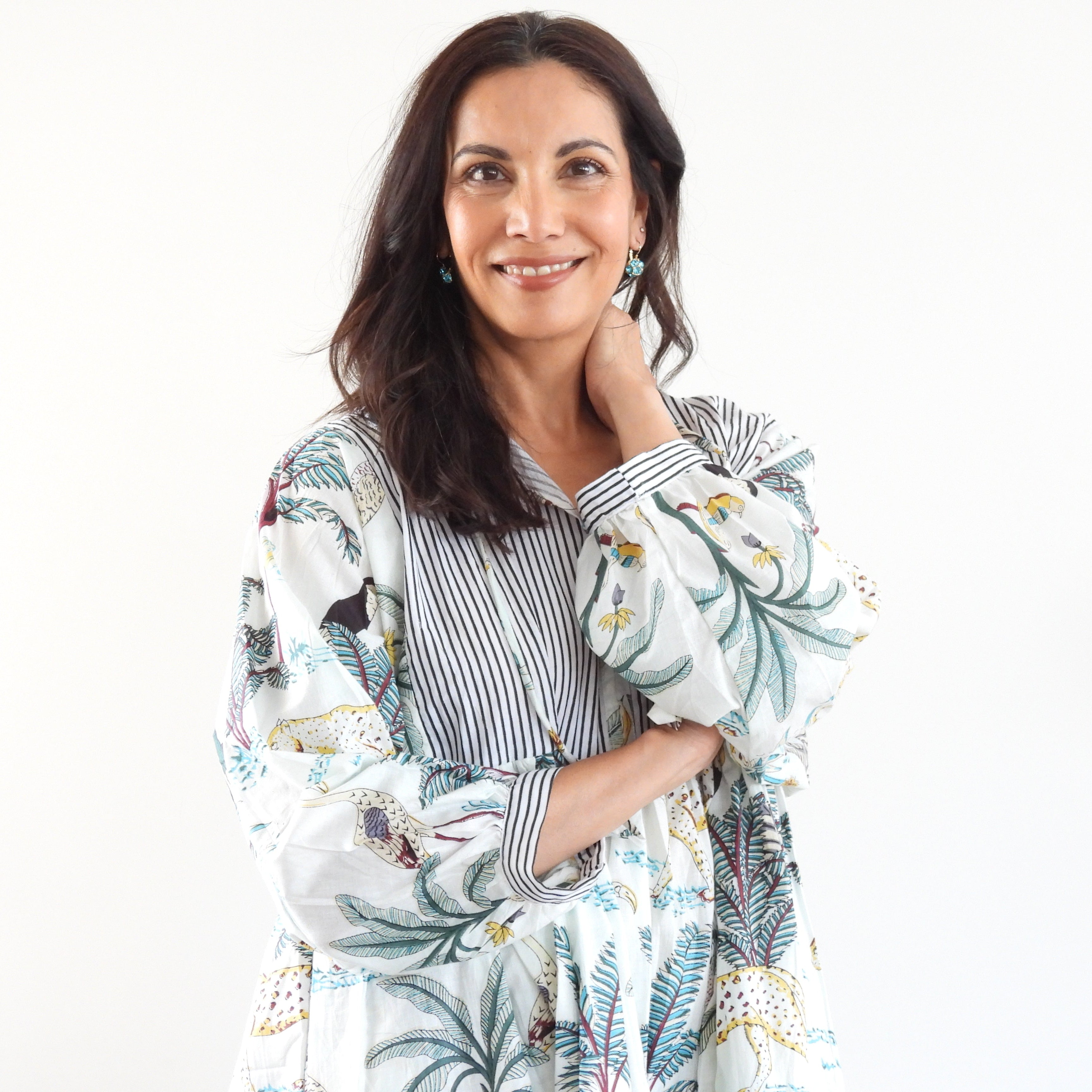 Woman wearing a white jungle print dress with striped yoke